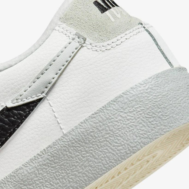 Shop Nike Blazer Low ’77 Split Sneakers in White, Black, and Grey. Featuring a leather & suede build with signature padded tongues and a unique “Split” design.
