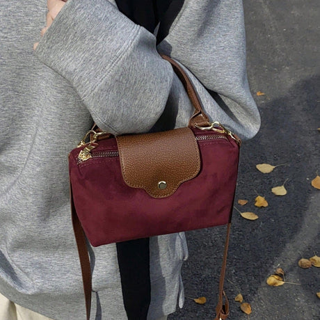 Retro Nylon Dumpling Bag - Attribute Details Style Fashionable Features Lightweight Color Burgundy Magnetic No Bag Size Mini Closure Type Zipper Strap Type Top Handle Details Buckle, Spiked Pattern Type Colorblock, Colorful Type Square Bag Coating 100% Po