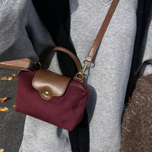 Retro Nylon Dumpling Bag - Attribute Details Style Fashionable Features Lightweight Color Burgundy Magnetic No Bag Size Mini Closure Type Zipper Strap Type Top Handle Details Buckle, Spiked Pattern Type Colorblock, Colorful Type Square Bag Coating 100% Po
