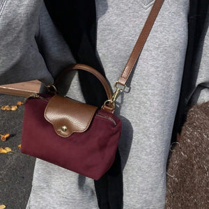 Retro Nylon Dumpling Bag - Attribute Details Style Fashionable Features Lightweight Color Burgundy Magnetic No Bag Size Mini Closure Type Zipper Strap Type Top Handle Details Buckle, Spiked Pattern Type Colorblock, Colorful Type Square Bag Coating 100% Po